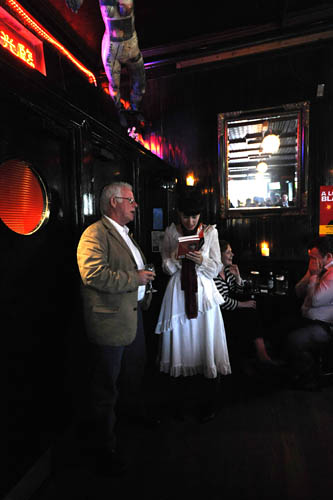 John B getting his book signed by Sue. To her left, a man breaks down and cries. Oh, the humanity.